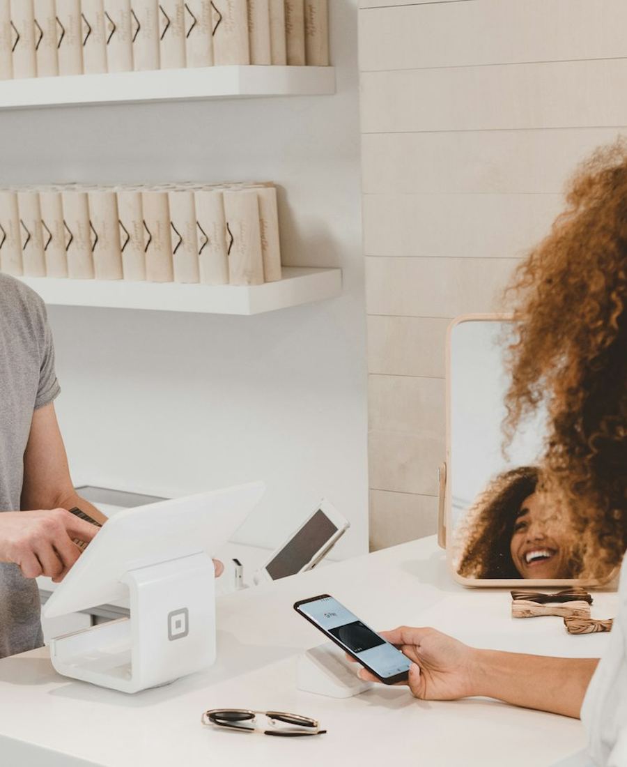 A shop owner helping a customer at the counter